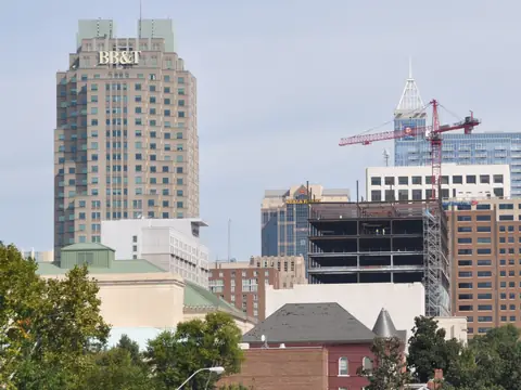 A downtown Raleigh tower above the trees and streetlights